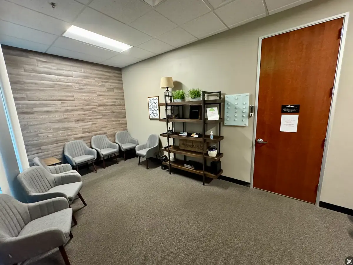 A bright waiting room at Advantage Mental Health with chairs and plants